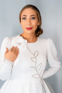 Model wearing the white FLORENCIA couture jacket with hand-beaded floral design on the chest.