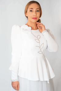 Model wearing the white FLORENCIA couture jacket with hand-beaded floral design on the chest.