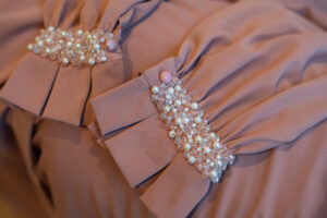 Nova kimono-style long dress — close-up of the ruffled cuff and pearl crystal beadwork in nude