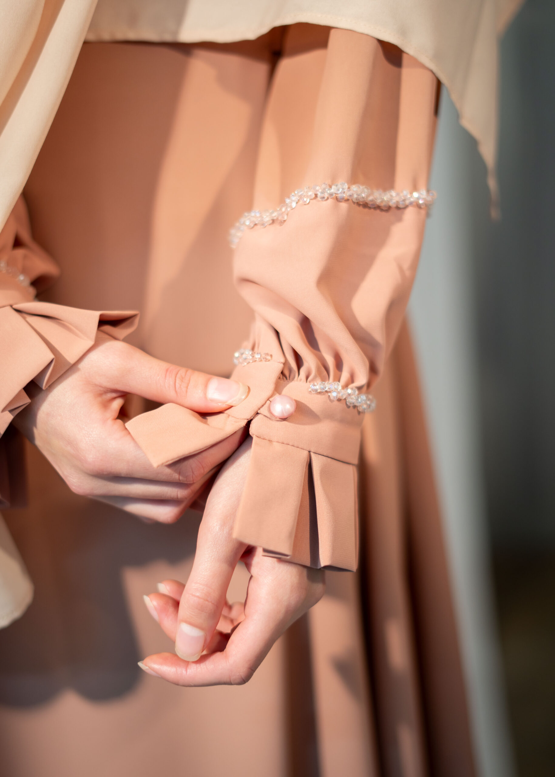 Hand-beaded sleeve cuff detail on the Nova kimono-style dress