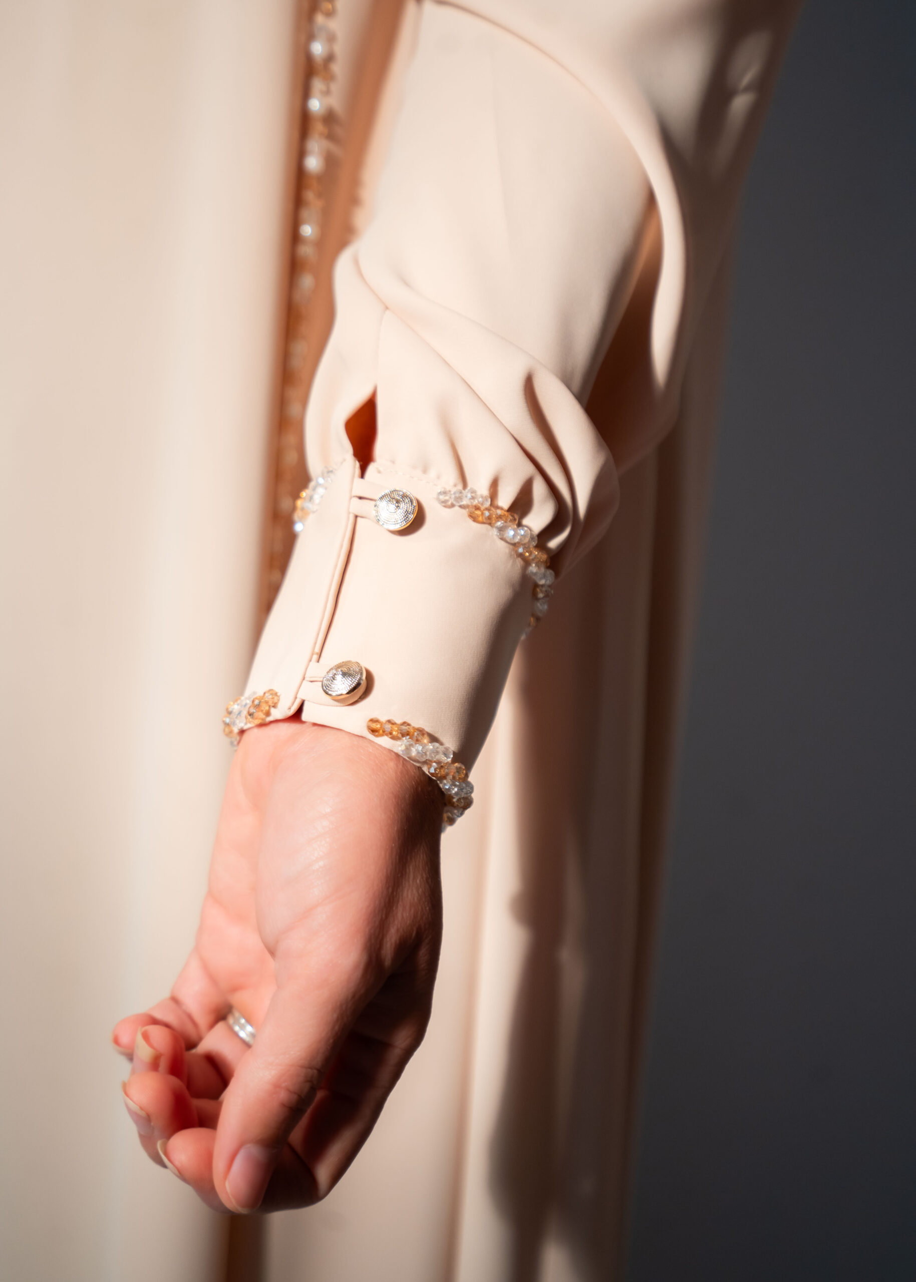 Waterfall beige abaya – close-up of hand-embellished crystal cuff