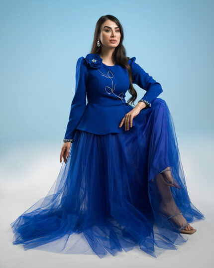 Royal blue couture peplum jacket with hand-beaded floral detail and matching tulle skirt on hanger.