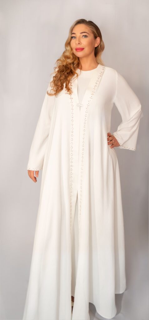 Adoria hand-embellished abaya in White – model front view”