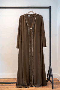 Front view of the Dark Brown Adoria Abaya on hanger – hand-embellished design
