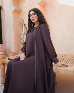 Handmade deep mauve brown waterfall dress with flowing silhouette, long sleeves, and hand-embroidered stone and bead detailing.