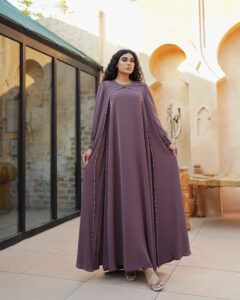 Handmade waterfall dress with flowing silhouette, long sleeves, and hand-embellished stone and bead embroidery.