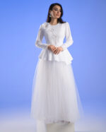 Model wearing the white FLORENCIA couture jacket with hand-beaded floral design on the chest.