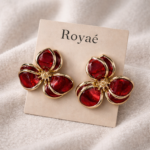 Royaé red floral statement earrings in gold setting on beige jewelry card