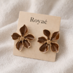 Royaé brown floral statement earrings with gold detailing on beige jewelry card