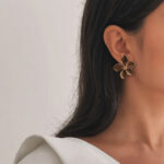 Royaé brown flower statement earrings worn by model