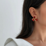 Royaé red flower statement earrings worn by model