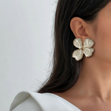 Royaé white flower statement earrings worn by model
