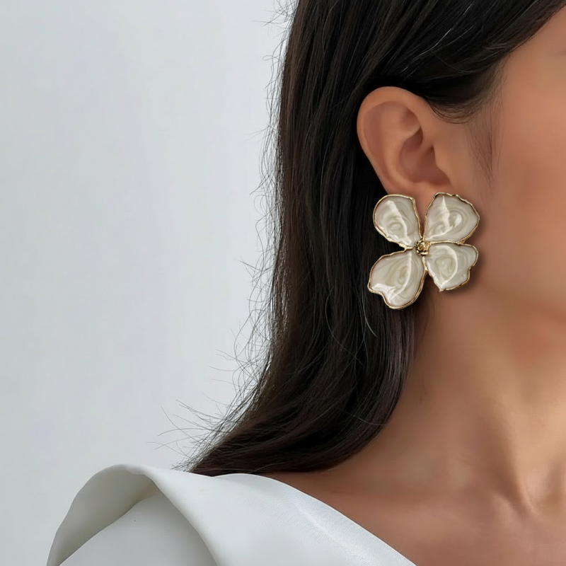 Royaé white flower statement earrings worn by model